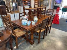 Hardwood dining table of farmhouse design together with a rush seate set of six (2 + 4) dining