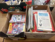 2 boxes containing football programmes