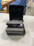 Box containing Polaroid camera, various scopes, Russian scope, flashes and a tripod