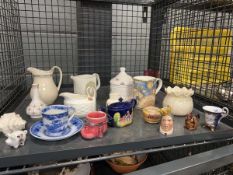 Cage containing a quantity of ornamental figures and milk jugs and cups and saucers