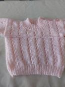Title: Hand Knitted Baby JumperDescription: Stunning baby jumper in pink.Hand knitted. ÊFastens with