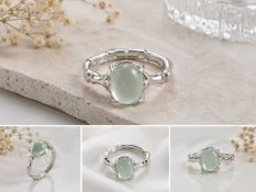 Title: Pale Green Cabochon Silver Tone Ring Description: Elegant silver-tone ring featuring a smooth