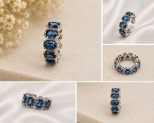 Title: Blue Oval Gemstone Eternity Ring – Silver Tone Description: Elegant eternity-style ring set