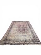A LARGE RED PERSIAN DESIGN CARPET