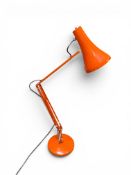 AN ORANGE ANGLEPOISE LAMP