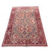 AN ANTIQUE PERSIAN-STYLE RUG
