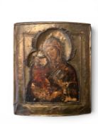 A 19TH CENTURY RUSSIAN ICON OF THE MADONNA AND CHILD WITH SILVER MOUNT