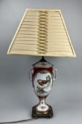 A URN TABLE LAMP ON A BRASS STAND WITH RIBBED CREAM SHADE BOUGHT FROM HARRODS