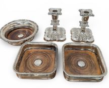 A COLLECTION OF SILVER PLATE TO INCLUDE CANDLESTICKS, COASTERS AND A SPOON