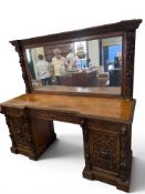 A VICTORIAN HEAVILY CARVED OAK MIRROR BACK SIDEBOARD