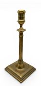 AN EARLY BRASS CANDLESTICK