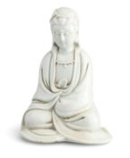 A CHINESE QING DYNASTY BLANC-DE-CHINE SEATED GUANYIN FIGURE
