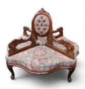 A VICTORIAN MAHOGANY CONVERSATION SOFA