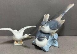 Two Lladro figures: Two Lovebird figures on a branch and a swan.