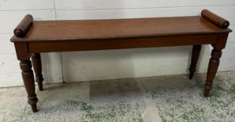 A late Victorian mahogany window seat on turned legs with cylindrical handles to ends - H47cm x