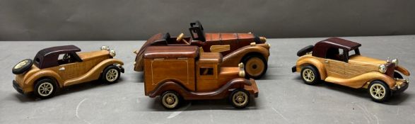 A selection of wooden ornamental cars Condition Report some chips