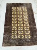 A wool Bokhara rug, mauve ground with octagonal central motifs (184cm x 125cm) Condition Report Good