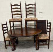 A Victorian style mahogany dining table with four ladderback chairs , the table being on claw feet