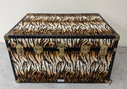 A storage trunk in a faux tiger skin fabric 75cm x 103cm x 58cm
