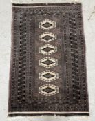 A wool rug with purple grounds and octagonal central shields (120cm x 81cm) Condition Report Some
