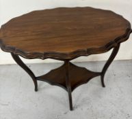 A Edwardian occasional side table with a scalloped top with shaped undertier on four slender