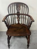 An antique Windsor armchair featuring a low U shaped arm bow with a central pierced back
