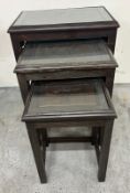 A carved nest of tables fitted with glass tops H59cm W53cm D32cm Condition Report marks to wood,