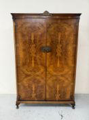 An Art Deco style wardrobe with a burr walnut veneer, brass fixings and on cabriole legs H190cm