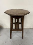 An oak Arts and Crafts style occasional table H72cm Dia50cm Condition Report some splits