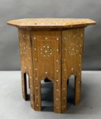 A Middle Eastern collapsible octagonal occasional table with mother of pearl inlay H31cm Dia31cm