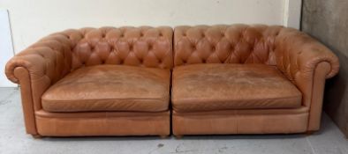 A four seater Chesterfield style sofa by Alexander James in a tan leather H70cm W260cm D116cm