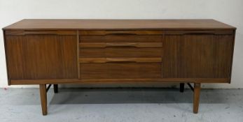 A Mid Century sideboard by Nathan, comprising of three graduated drawers flanked by cupboards