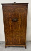 A Queen Anne style gentleman's wardrobe in a distinctive burr walnut veneer and fitted interior