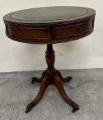 A mahogany drum table with leather top on turned column and brass claw feet H60cm Dia50cm
