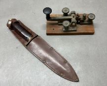A military morse code telepgraph key and a WWII fighting knife by Taylor Witness of Sheffield