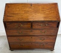 A mahogany bureau comprising of two short drawers over three long, the fall opening to a central