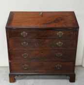 A mahogany bureau comprising of four graduated drawers with a fall opening to a writing surface,