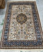A wool rug beige grounds with a central sheild and a geometric border 290cm x 190cm