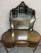 A walnut veneer dressing table with three mirrors, large centre drawer flanked by drawers either