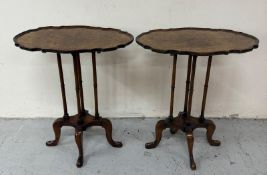 A pair of walnut veneer mahogany occasional tables with piecrust tops, spindle supports and on