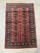 A wool rug with pink grounds and a geometric border (130cm x 78cm) Condition Report Good condition