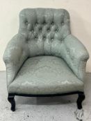 Button back armchair in pale green upholstery and dark wooden legs