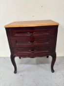 A three drawer bedside cabinet featuring carved details H60cm W52cm D34cm Condition Report solid