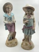 Two porcelain figurines of a boy and girl H39cm