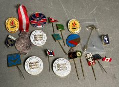 A collection of sporting pin and badges of various countries and years