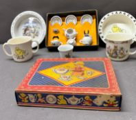 A vintage children's porcelain tea set in its original box with varied kids' dishes and cups