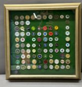 A framed, mounted selection of collectable golf ball markers