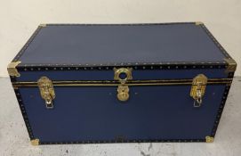 A Jonelle storage trunk in blue with brass fittings H54cm W103cm D52cm