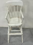 A stick-back tall children's chair painted white