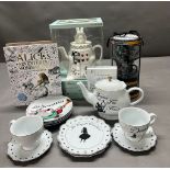 A selection of Alice in Wonderland memorabilia to include teapot, saucers and cups